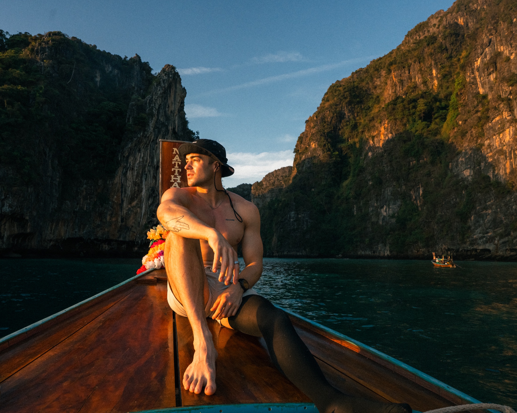 A longtail boat between the cliffs of Thailand